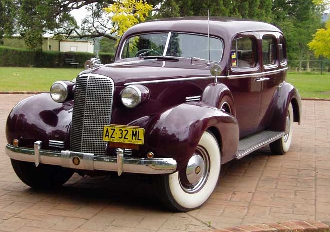 Brown Cadillac car sitting in driveway