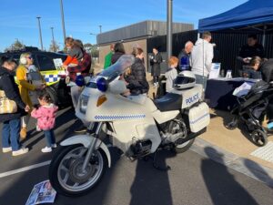 Glen Huntly first car show vintage police motorcycle on display with kids asking questions about the motocycle