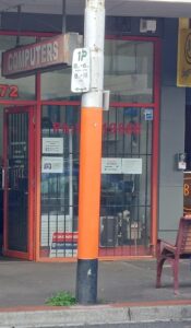 Glen Huntly lamp post painted orange colour to bring back good vibe to Glen Huntly shopping precinct