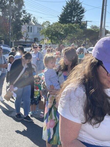 Easter Glen Huntly event outside Major Mitchell with line of people and kids for easter bags
